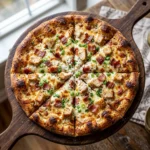 Delicious Chicken Bacon Ranch Pizza topped with crispy bacon and creamy ranch sauce.
